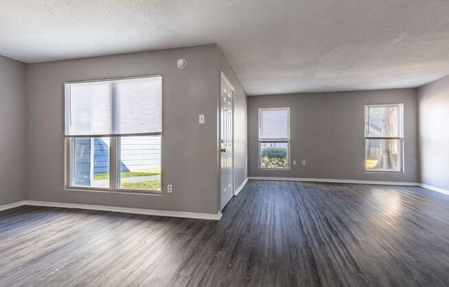 Whitney Manor Apartments in Gretna, LA photo of  an empty living room with wood floors and a window