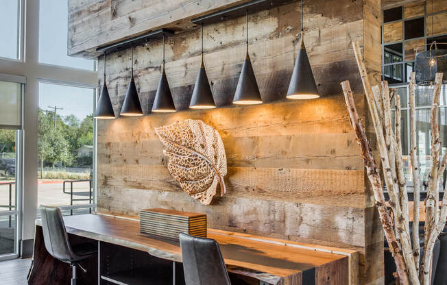 a conference room with a wooden wall and a desk with chairs