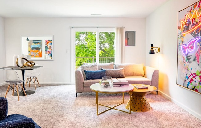 a living area with a couch coffee table and a desk with a chair