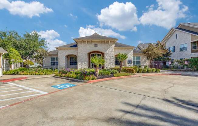 A parking lot with a handicap parking space in front of a building.