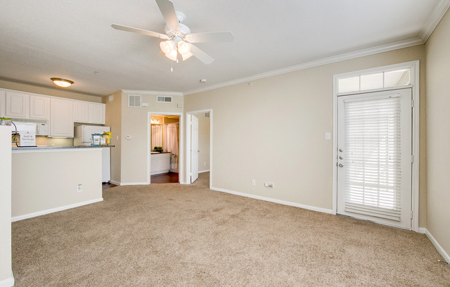 View of Classic Apartment Interior, Showing Living Room with Ceiling Fan, View of Kitchen and Bathroom at Stonebriar of Frisco Apartments