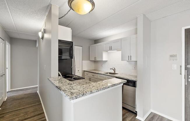 a kitchen with a granite counter top at Troy Place Apartments - Troy, MI, Michigan