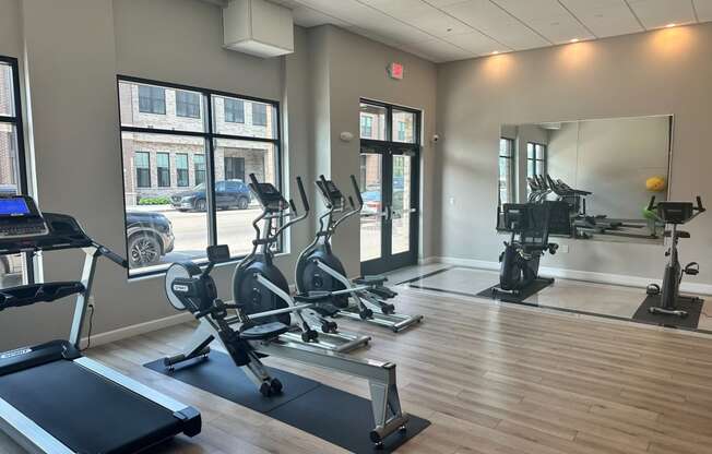 a gym with treadmills and other exercise equipment at the belgard apartments