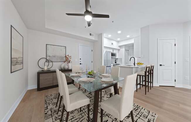 a living room and dining room with a table and chairs