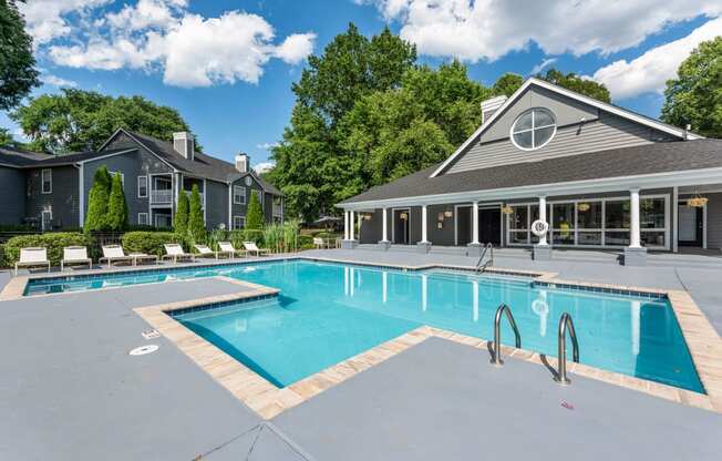 a swimming pool with a house in the background