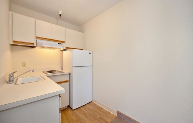 a kitchen with white appliances and a white refrigerator