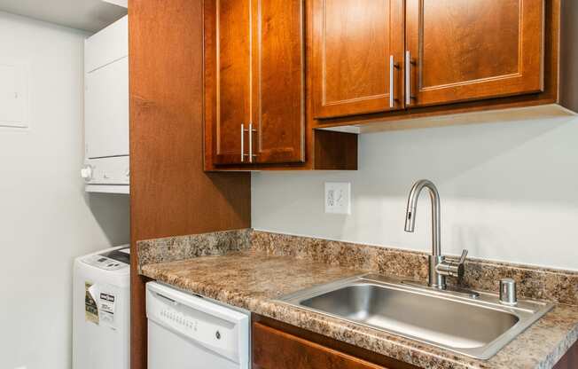 Kitchen area with washer and dryer and dishwasher  at Falls Village Apartments, Baltimore, MD, 21209