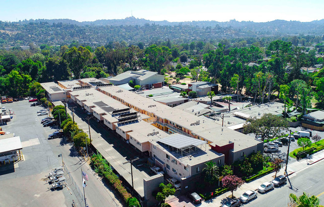 Aerial drone photo of Woodbridge Park Apartments, showing white solar roofs and Solar Panels.