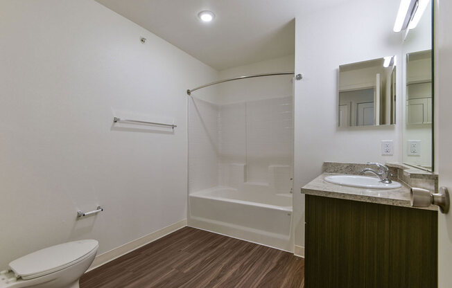 a bathroom with a toilet sink and showerat Chase Creek Apartment Homes, Alabama, 35811