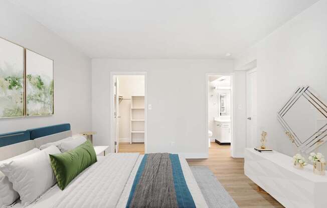 A bedroom with a large bed and a painting on the wall.