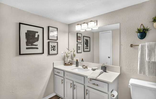 a white bathroom with a sink and a mirror