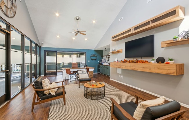 a living room with a couch and chairs and a tv