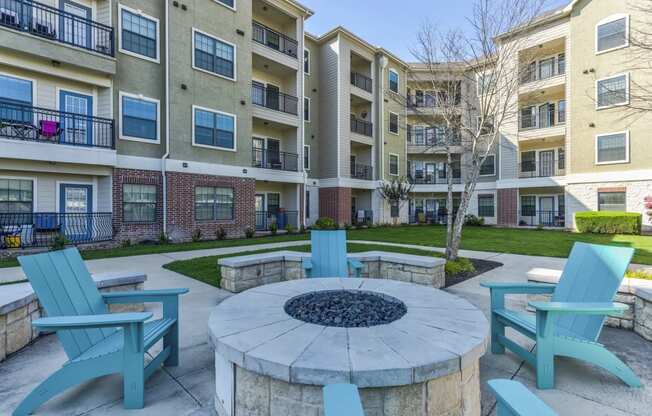 an outdoor firepit and lounge area at the bradley braddock road station apartments