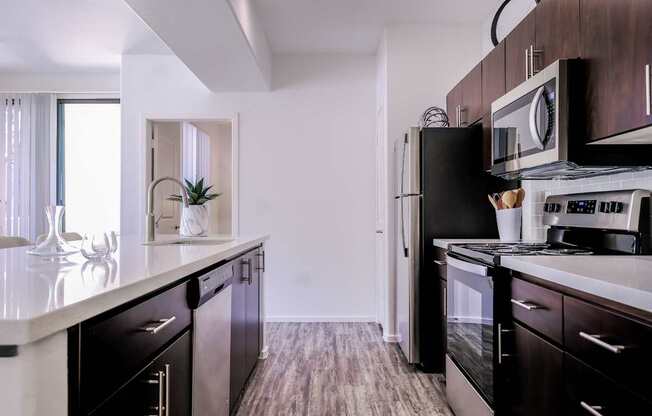 luxury kitchen with stainless steel appliances at Avora apartments