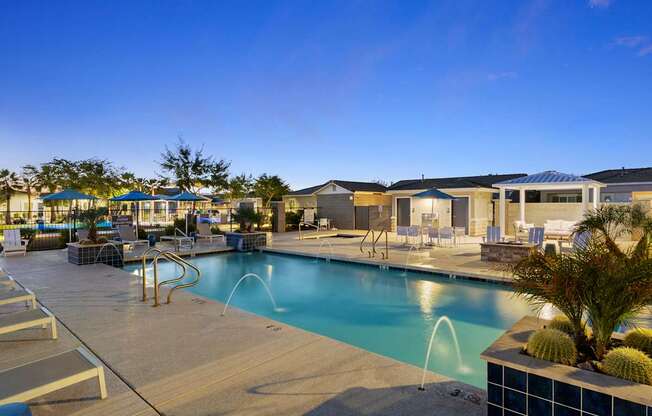 A pool area with a blue pool and a slide.