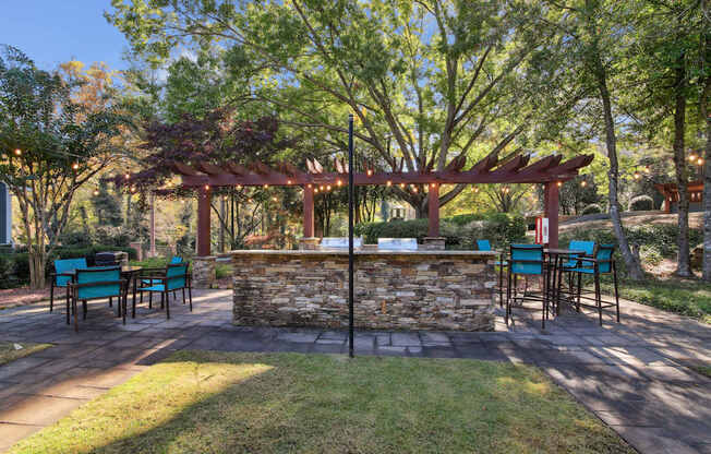 A patio with a table and chairs under a pergola.