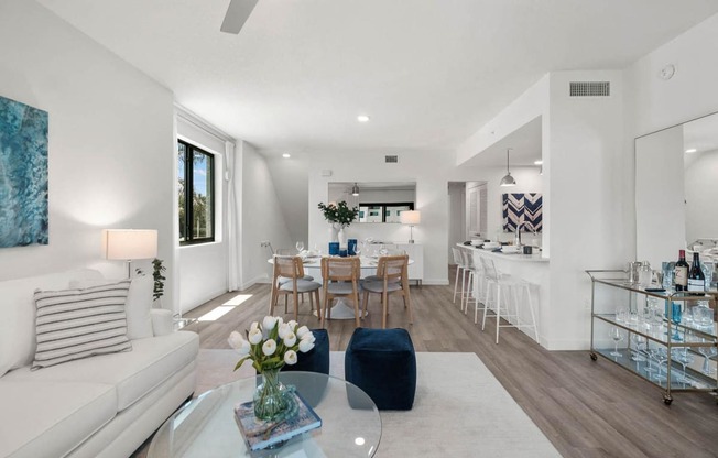 a living room with a couch and a table at Altis Santa Barbara, Naples, Florida