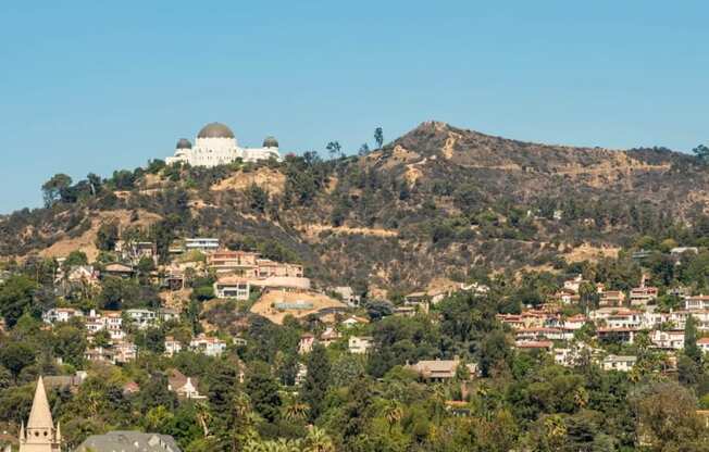 A small town with a large hill in the background.