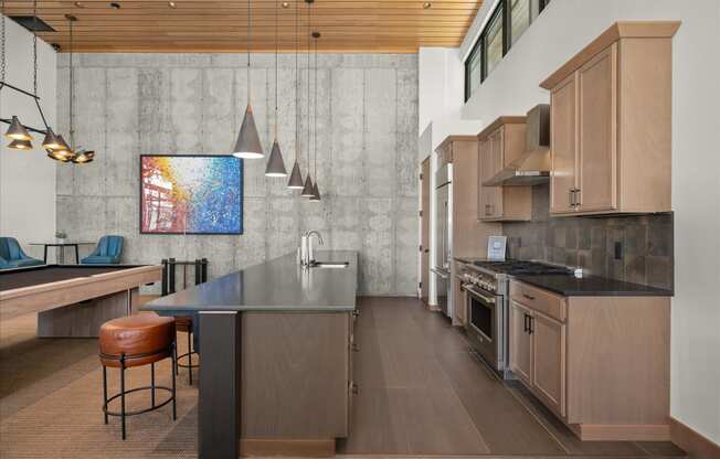 the kitchen has a large island and stainless steel appliances