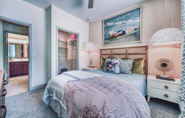 A bedroom with a bed, a dresser, and a painting on the wall.