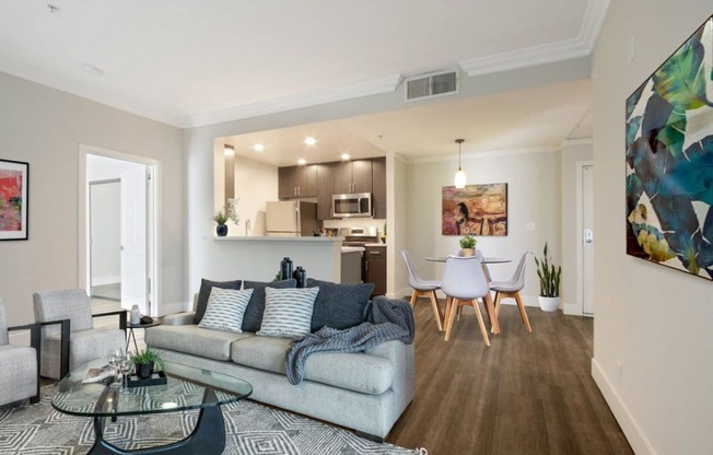 a living room with a couch and a table with chairs