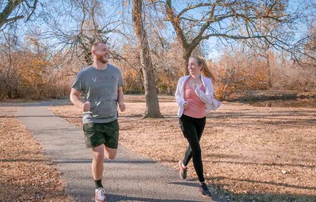 A man and a woman running down a road at Legends of River Oaks