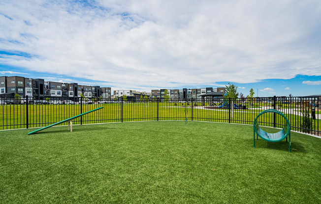 a playground with a swing set on a lush green field