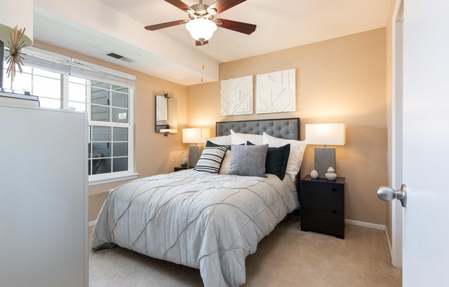 a bedroom with a large bed and a ceiling fan