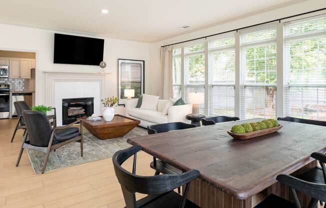 a living room with a table and chairs and a fireplace