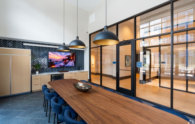 a dining room with a wooden table and blue chairs at Preston Ridge, Cary, NC