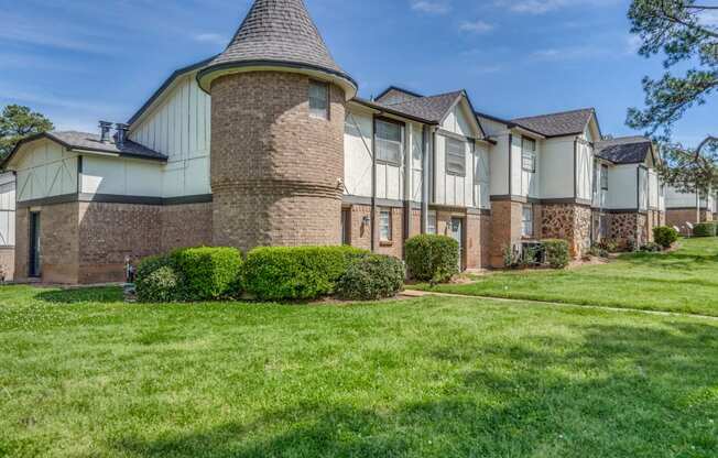 a large house with a yard in front of it