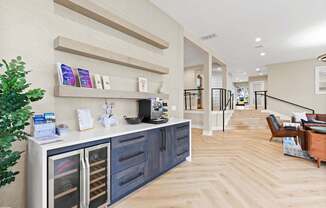 A modern kitchen with a wooden floor and a white wall.