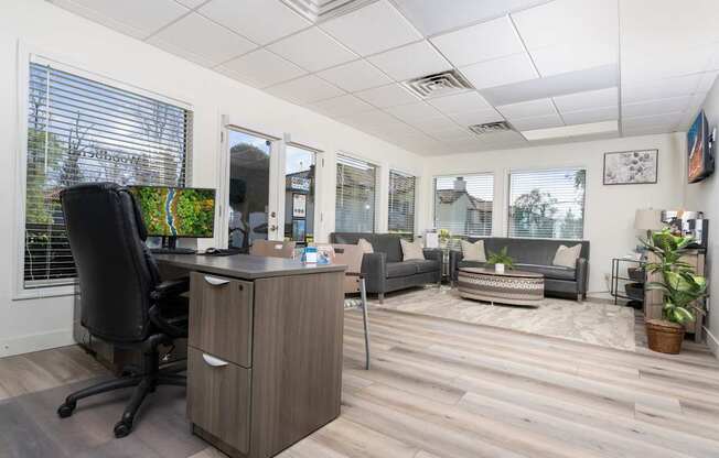 A room with a desk and a couch.