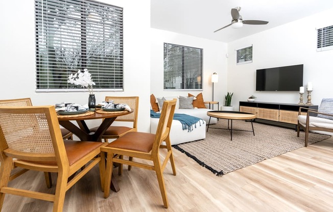 a living room and dining room with a couch and a tv