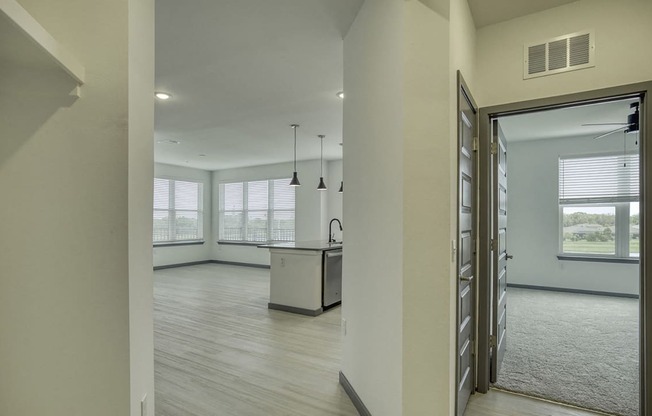an open kitchen and living room with a large window