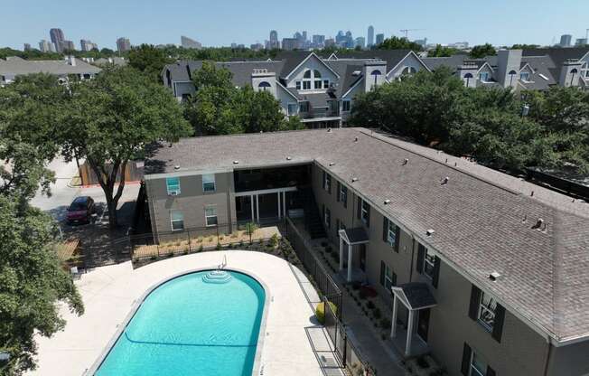 an aerial view of an apartment building with a swimming pool