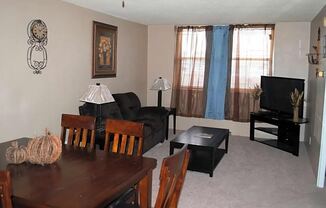 a living room filled with furniture and a flat screen tv