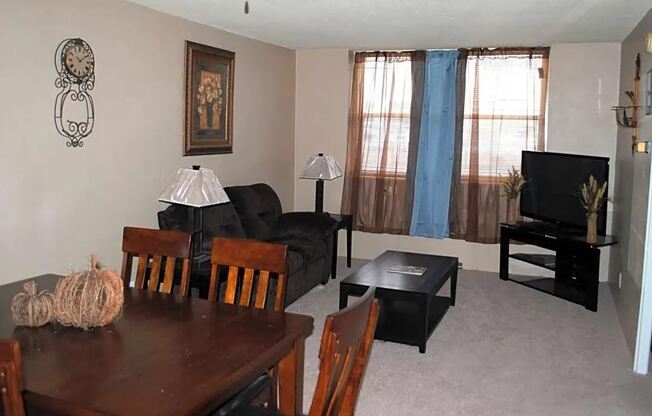 a living room filled with furniture and a flat screen tv