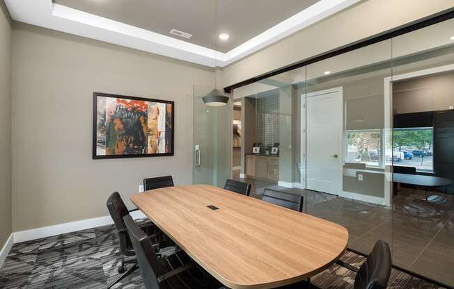 A conference room with a large table and chairs.