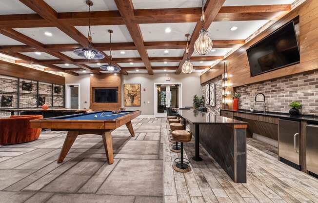 a game room with a pool table and a tv