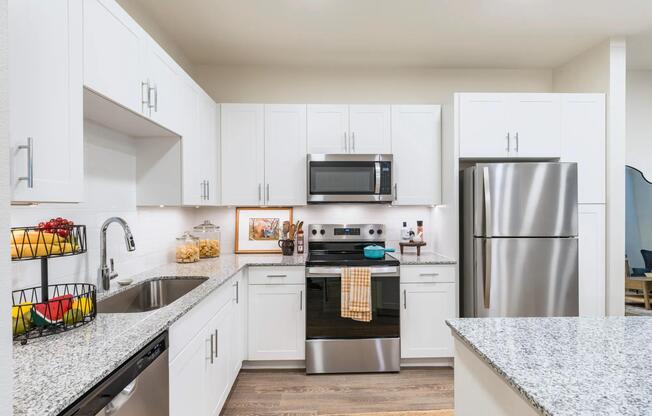 Kitchens with stainless steel appliance package, single-basin sink with pull-down faucet, and stylish tile backsplash.