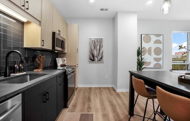 an open kitchen and dining room with a table and chairs