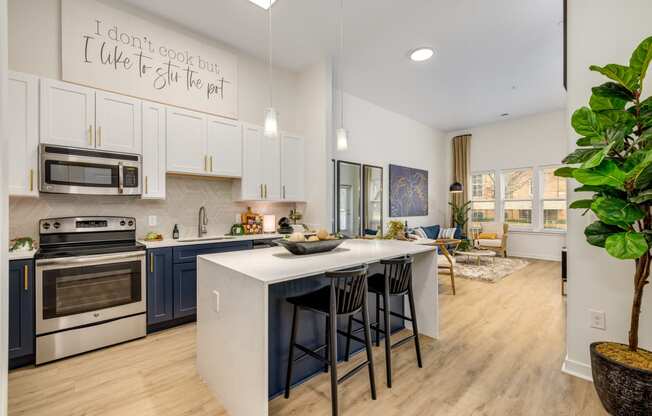 A greatroom and kitchen with center island, offered at Midtown 205, recognized as best apartments in Charlotte, NC.