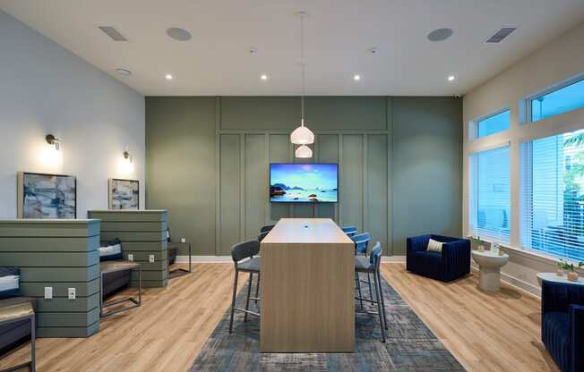 a conference room with a table and chairs and a television