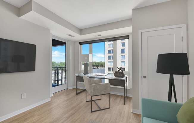 a bedroom with a desk and chair in a 555 waverly unit