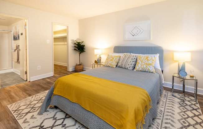 a bedroom with a bed and a yellow blanket