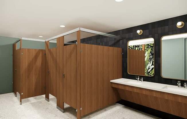 A bathroom with wooden stalls and sinks.