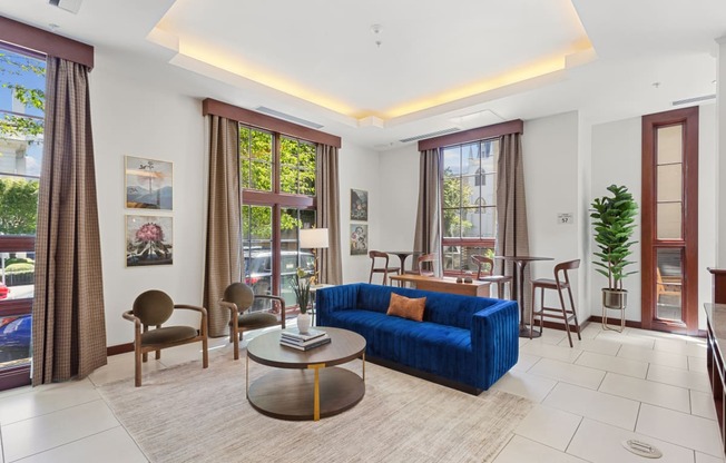 a living room with a blue couch and a table