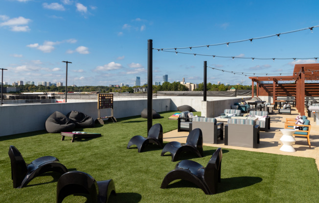 Rooftop green area with lounge seating and games