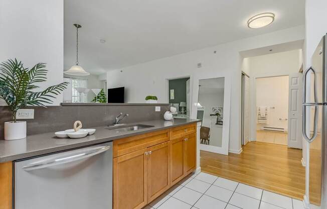 A modern kitchen with wooden cabinets and a white fridge.